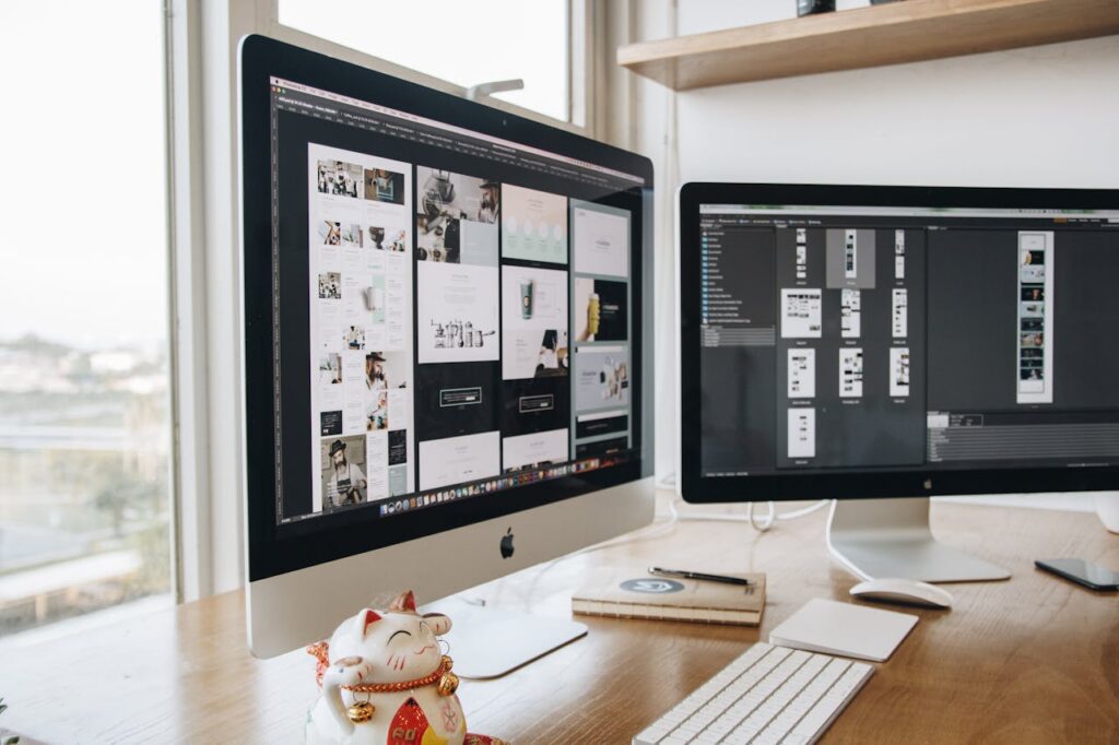 A stylish workspace featuring dual monitors and a lucky cat figurine, ideal for technology and design themes.
